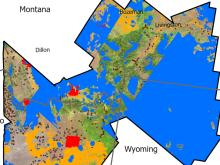 Pictured is satellite imagery of portions of Montana, Idaho, and Wyoming. Portions of the map are colored blue for areas of EMIT and SAR data masking. Yellow where there is landing cover masking. Red where high-resolution model training was used. Dots for training point data. And white to show the total area of analysis extent.