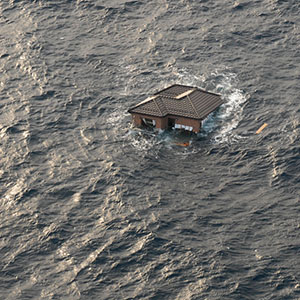 A Japanese home drifts in the Pacific Ocean a few days after the March 11, 2011, earthquake and tsunami in northeastern Japan.