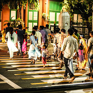 Photograph of people crossing a crosswalk at night