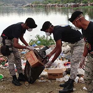 In the Dominican Republic, workers clean up potential mosquito-breeding containers