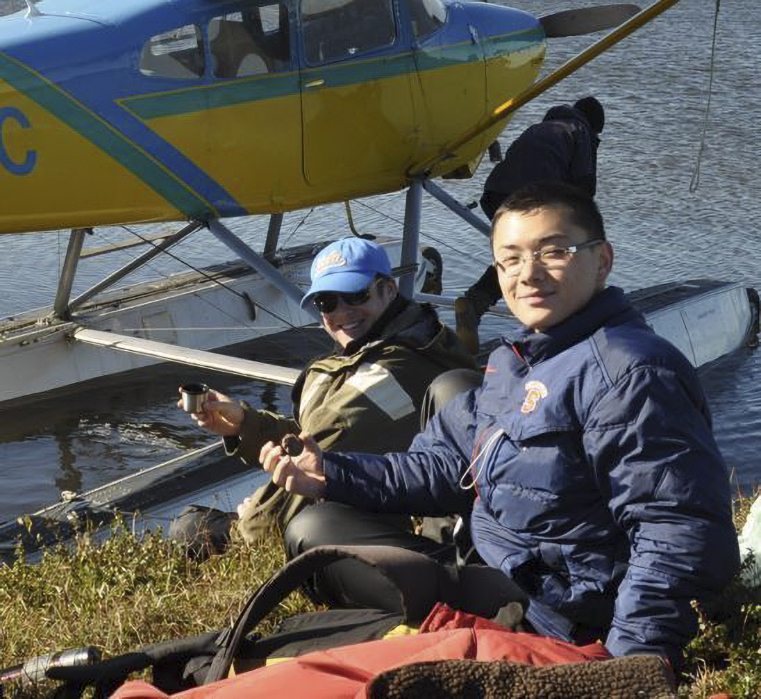 Thumbnail image of Dr. Wang standing outside a sea plane in daytime.