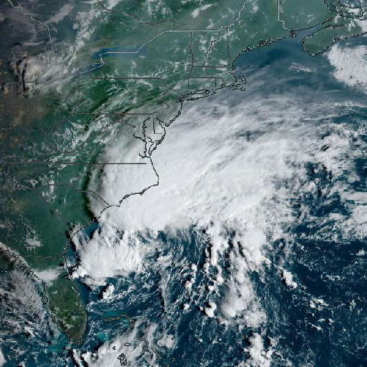True color image of large white clouds moving up the U.S. East Coast
