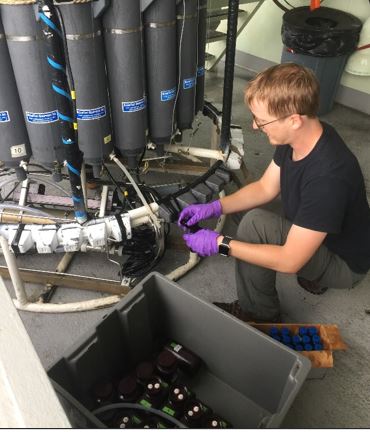 Allen retrieves samples from a CTD Rosette, which collects water samples at specified ocean depths. 