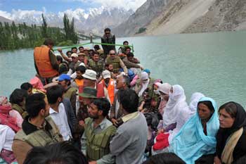 Photograph of a ferry full of people crossing Lake Gojal