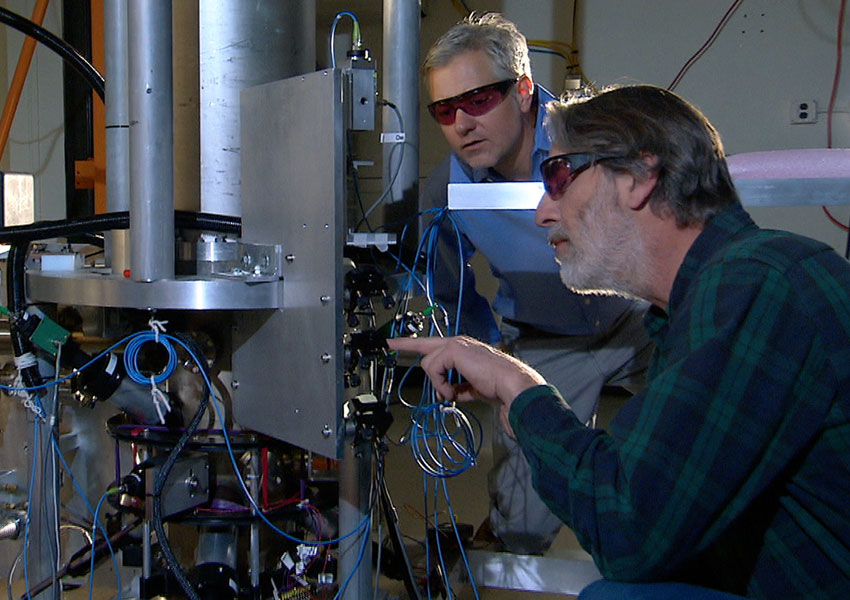 Photograph of scientists examining an atomic clock