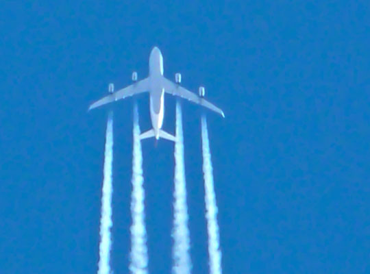 Photograph of an aircraft and contrails