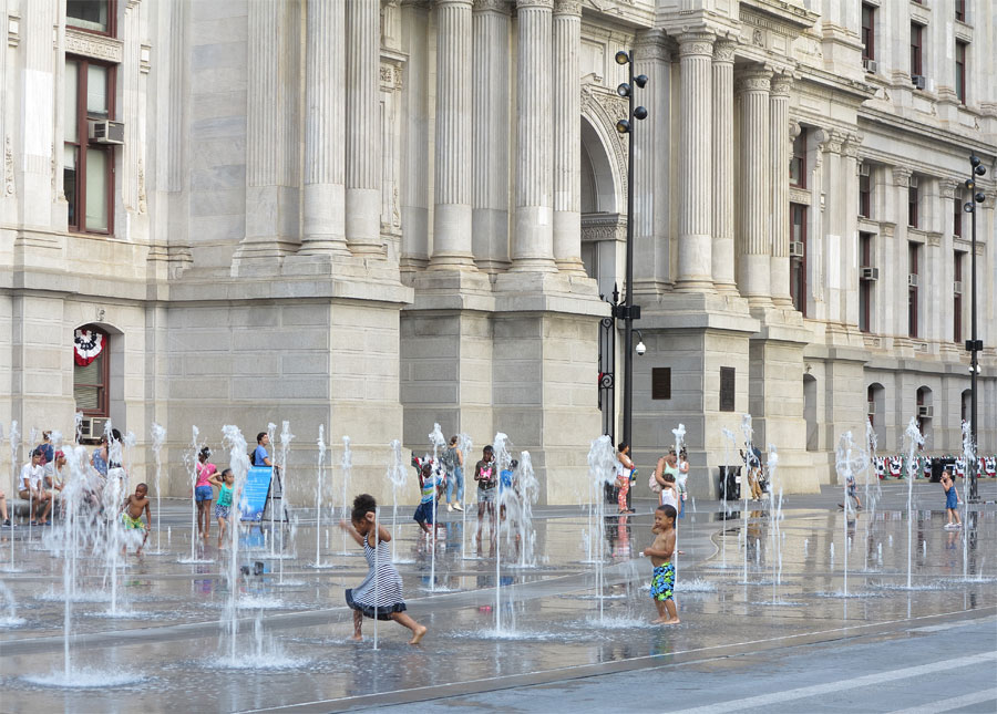 Photograph of children playing in fountains