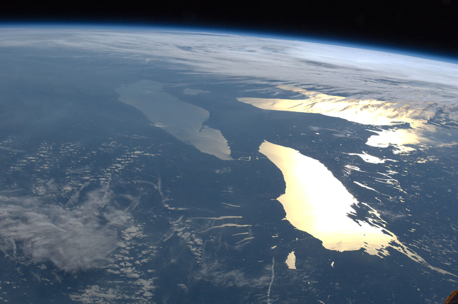 Aerial photograph showing several of the Great Lakes glinting in the sun
