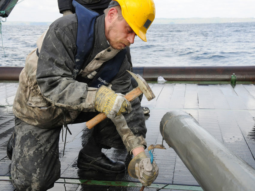 Photograph of scientist Hans Roy extracting a core