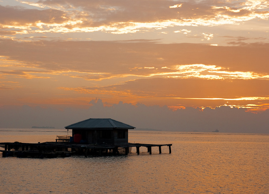 Photograph of a sunrise over a fishing platform in the Java Sea