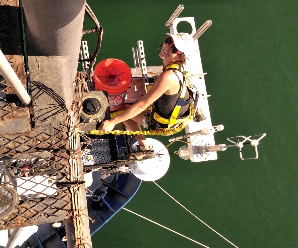 Kyla Drushka installs a disdrometer, an instrument that measures the size of individual raindrops, on mast of the ship R/V Revelle during the SPURS-2 project.