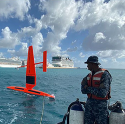 Photograph of Saildrone and researcher