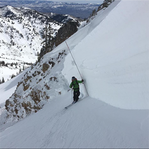 Photograph of a citizen scientist measuring snow depth