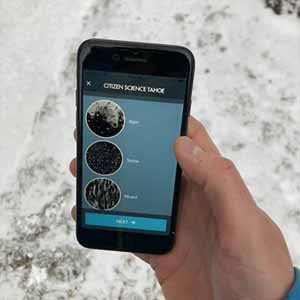 Hand holding phone with mobile application for collecting precipitation phase observations