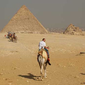 The city of Cairo is barely visible behind the pyramids in this photograph, due to the heavy layer of haze. 
