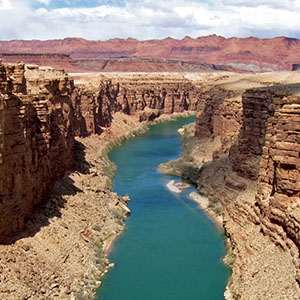 As viewed from the Navajo Bridge near Lee's Ferry, Arizona, the Colorado River flows through a range of arid landscapes. 