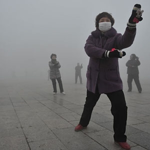 Retirees perform tai chi during a smoggy day in Fuyang, China in January 2013. 