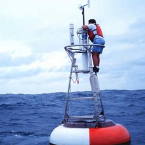A worker maintains a Tropical Atmosphere Ocean (TAO) buoy on the equatorial El Niño array in the Pacific Ocean. 