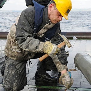 Scientist Hans Røy opens a core sample drilled from the Pacific Ocean seafloor. 