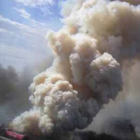 Smoke rising from the Chain Lakes fire on June 27, 2004, in Yukon Territory, Canada.
