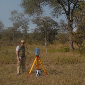 Researcher Michel Verstraete pauses while a laser scanner records the geometric properties of a savanna landscape in Kruger National Park, South Africa