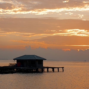 The sun rises over a fishing platform in Kepulauan Seribu (Thousand Islands) in the Java Sea.