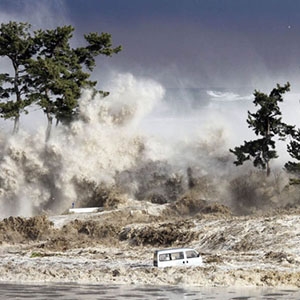 A tsunami strikes northeast Japan after the 2011 Tohoku Earthquake, generating waves up to 133 feet high along some areas of the coast.