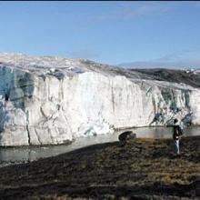 A researcher observes the edge of the Greenland Ice Sheet in 2001. (Image courtesy of Ted Scambos, National Snow and Ice Data Center, University of Colorado at Boulder).