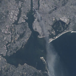 This photograph shows the smoke plume from the World Trade Center collapse drifting over New York City and New Jersey on the morning of September 11, 2001.
