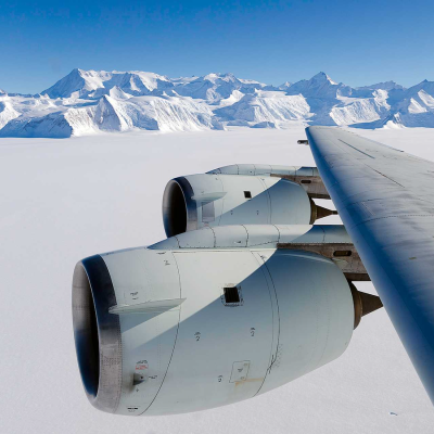 Photo of aircraft wing in flight over arctic on a clear day
