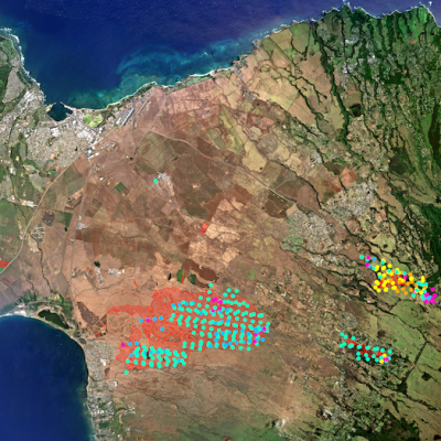 Satellite image of brown land with blue ocean at top and bottom; city seen in far left side; colored circles indicate detected hotspots