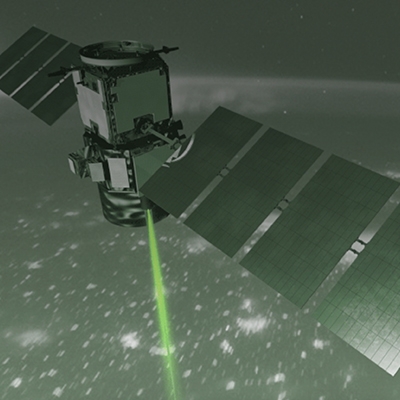 Image from space of a satellite with a green laser projecting downward at the Earth