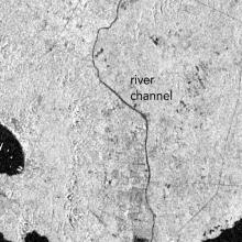 A black and white Synthetic Aperture Radar image showing increased water extent in the La Sabana River.