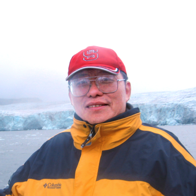 Headshot of li outside with arctic ice behind him