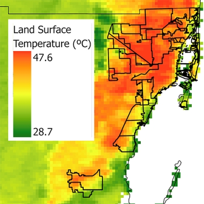 This image shows a temperature map of South Florida and Miami-Dade County using MODIS data. Areas on the right side of the image are in the county and along Florida’s Atlantic coast. These areas are colored in variations of yellow, orange, and red to indicate higher land surface temperatures. The surrounding area is largely colored in shades of green to show lower temperatures. A temperature scale in Celsius is also included showing the range of temperatures from green to red to be from 28.7 to 47.6 deg.