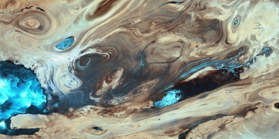 Swirling browns and blues comprise a satellite image of Earth