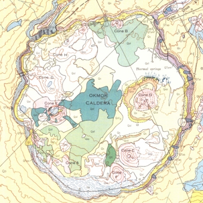 A color topographical map of Okmok volcano with labels for its caldera, cinder cones, and other features. 