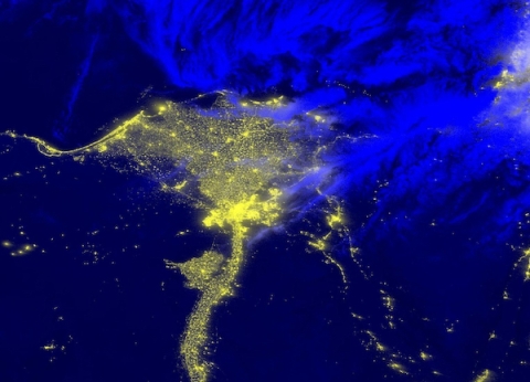 Bright yellow lights of triangular Nile delta at night.