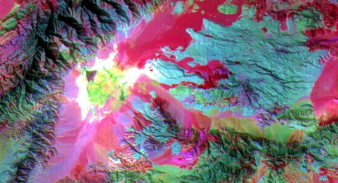 A false-color image of the Saline Valley in California shows different types of rock, vegetation and soil in various colors.
