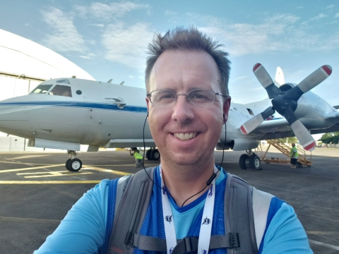 Dr. Timothy Lang poses with a NASA’s P-3 research aircraft used in the Cloud, Aerosol and Monsoon Processes Philippines Experiment. 