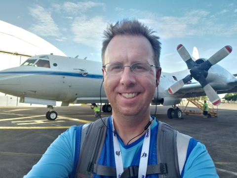 Dr. Timothy Lang poses with a NASA’s P-3 research aircraft used in the Cloud, Aerosol and Monsoon Processes Philippines Experiment. 