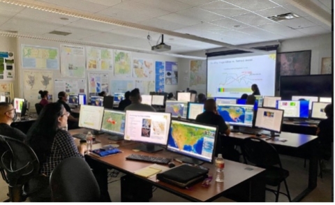 image of classroom with students learning from NASA ESDS team members.