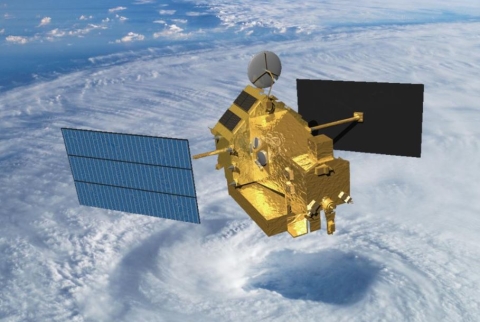 An artist's illustration of the Tropical Rainfall Measuring Mission satellite in space over a hurricane. 