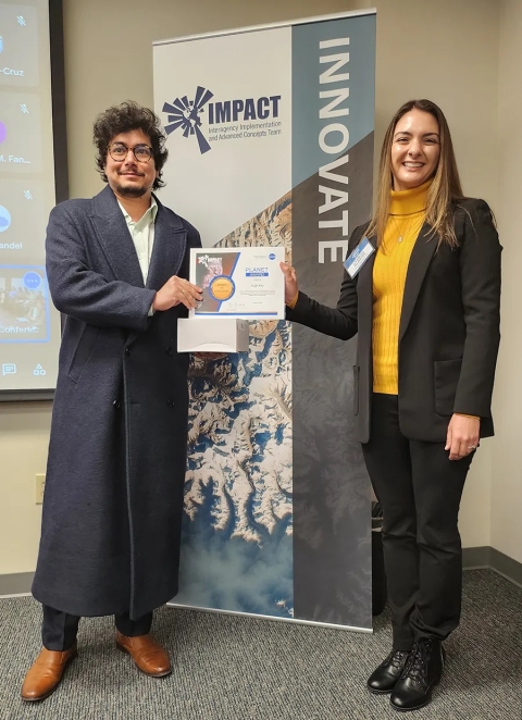 Cerese Albers presents Sujit Roy with an IMPACT Award while standing in front of an IMPACT Innovate banner