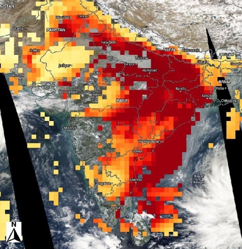 NASA worldview image of India showing extremely high aerosol concentrations indicated in red roughly tracing the outline of the milky white layer in the previous image.