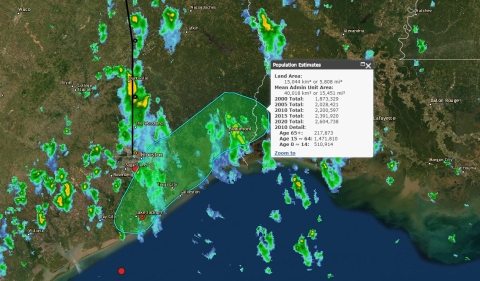 Screenshot of the GeoCollaborate dashboard showing the Gulf of Mexico, colored areas indicating heavy rain, and a green polygon indicating an area for which a population estimate is being acquired. Population estimate numbers are displayed in a square box to the right of the polygon.