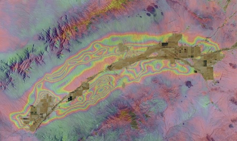 An InSAR image of the McMullen Valley groundwater basin in south-central Arizona showing the colored fringes indicating changes in elevation between 2010 and 2015. Each complete color sequence fringe in this image, from blue to blue, indicates 2.8 cm (1.1 in) of elevation change. Image courtesy of ADWR.