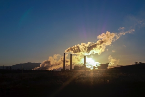 Smoke stacks at a power-generating facility. Burning fossil fuels for electricity is a source of greenhouse gas emissions.