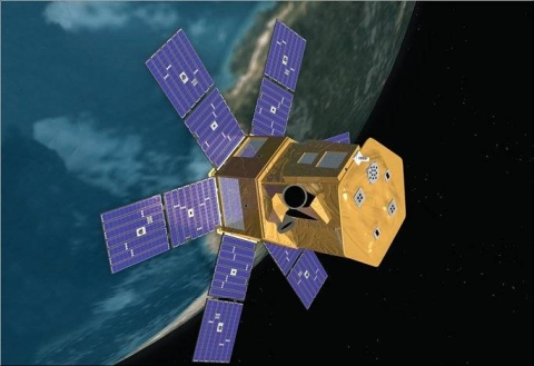 Image of SORCE satellite with six solar panels coming off a rectangular gold-covered bus. Earth is in the background.