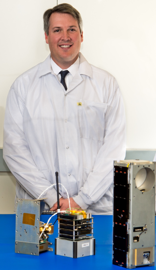 Dr. William J. Blackwell poses with an early prototype of TROPICS CubeSat